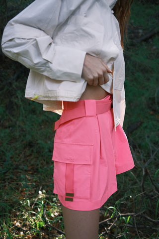 Woman in the woods wearing SENIQ Trailmix Short, Dirtpop Trek Jacket, Oasis Tank