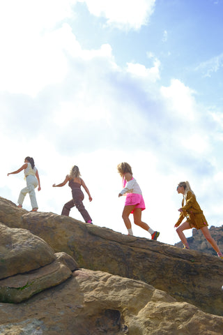 Women hiking on rocky terrain wearing SENIQ Technical Outdoor Clothing