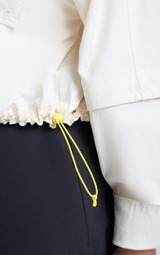 Details of woman wearing SENIQ Dirtpop Trek Jacket and Trailmix Pants