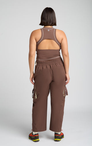 Woman wearing outdoor technical gear designed by SENIQ. Oasis Tank, Trailmix Pant. lightweight, durable, 4-way-stretch pant.