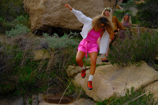 Group of women hiking outdoors wearing SENIQ technical apparel