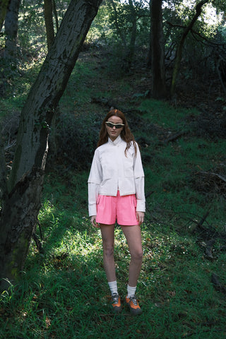 Woman wearing Trailmix Short System including the Dirtpop Trek Jacket, Oasis Tank, and Trailmix Short by SENIQ. Apparel designed for movement.