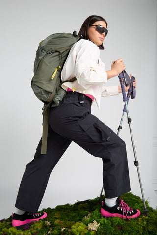 Woman wearing SENIQ Trail System including Dirtpop Trek Jacket, Oasis Tank, Trailmix Pant