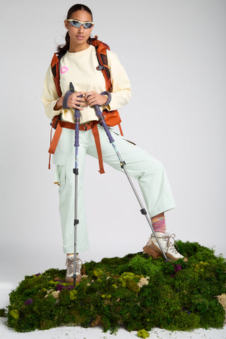 Woman wearing SENIQ Trail System including Dirtpop Trek Jacket, Oasis Tank, Trailmix Pant