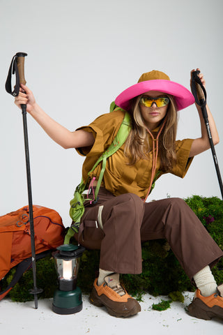 Women in outdoors gear designed by SENIQ. Trailmix Reversible Sunhat, Trailmix Pants