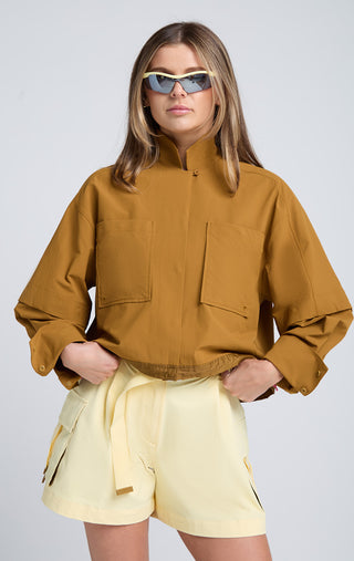 Woman wearing SENIQ Dirtpop Trek Jacket and Trailmix Shorts