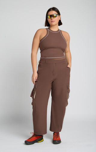 Woman wearing outdoor technical gear designed by SENIQ. Oasis Tank, Trailmix Pant. lightweight, durable, 4-way-stretch pant.