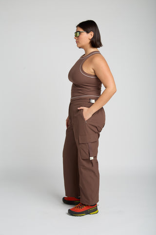 Woman wearing outdoor technical gear designed by SENIQ. Oasis Tank, Trailmix Pant. lightweight, durable, 4-way-stretch pant.